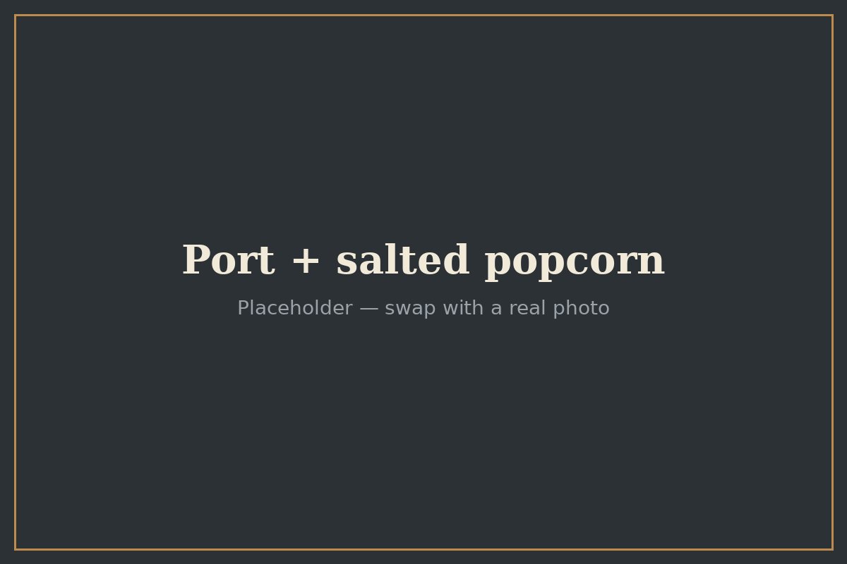 A glass of Port served with a bowl of salted popcorn