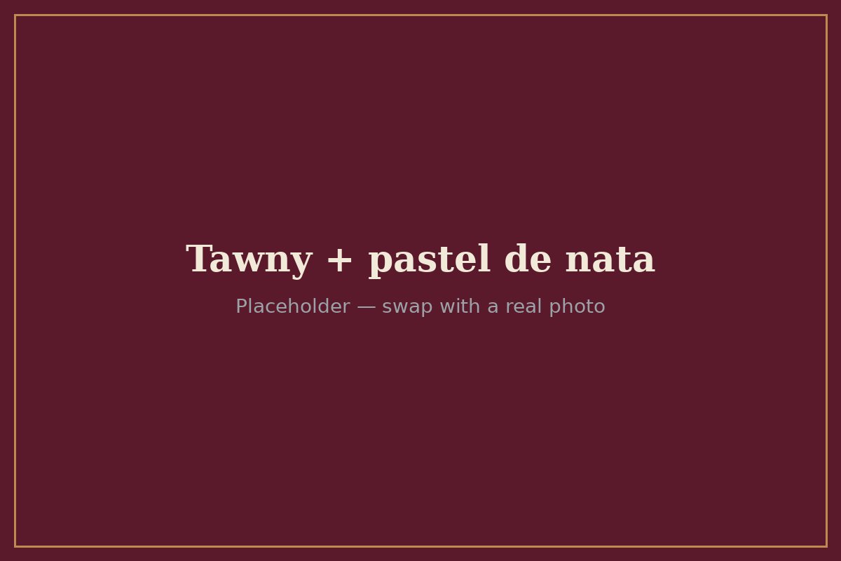 A glass of Tawny Port next to a pastel de nata